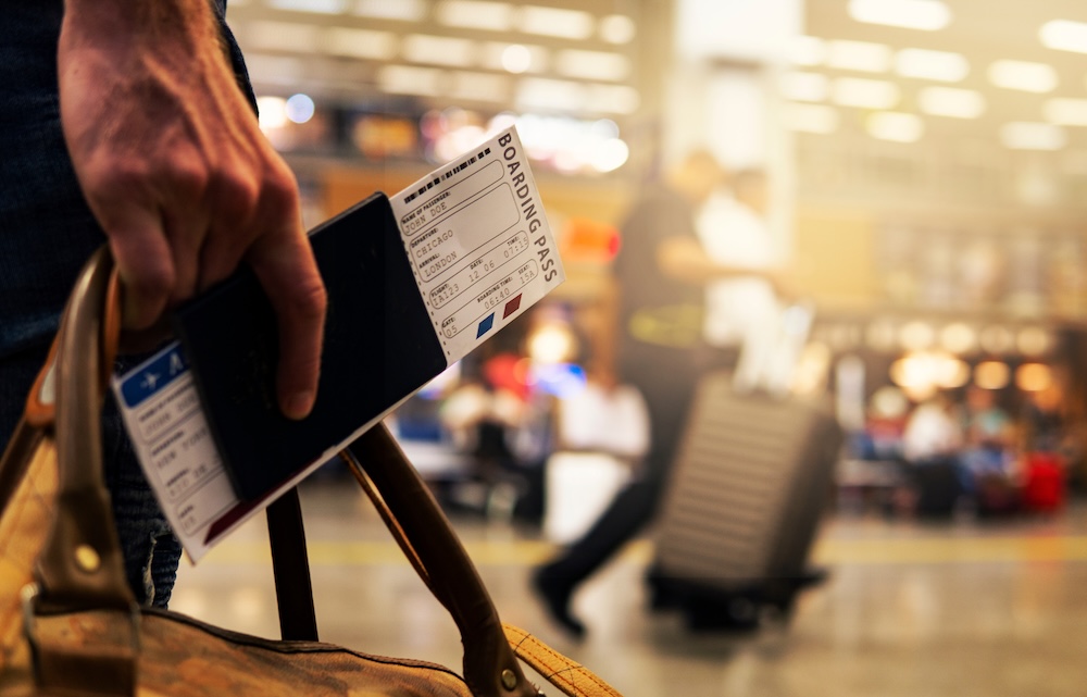 Boarding Pass Close Up In Crowded Airport Terminal