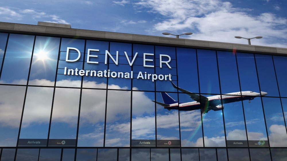 Airplane landing at Denver Colorado mirrored in terminal