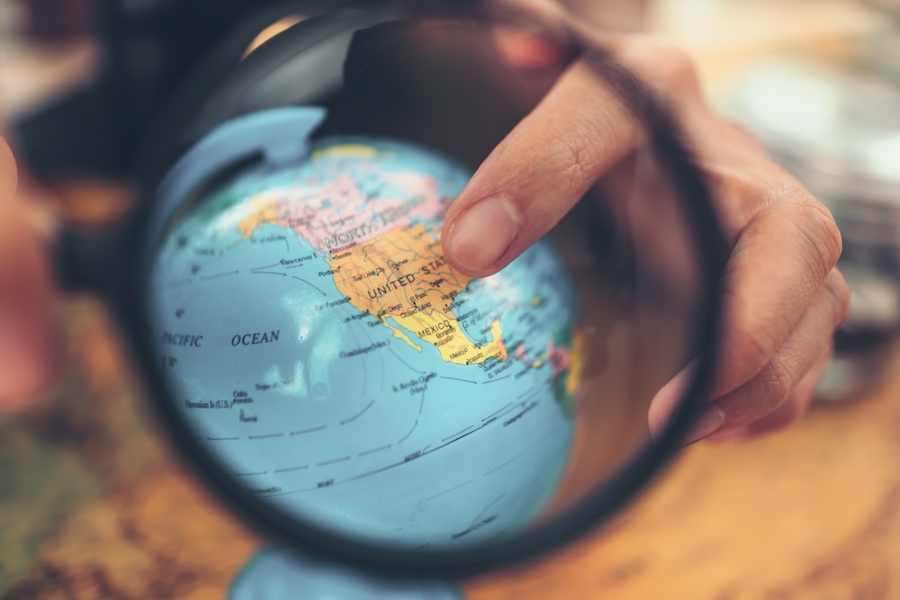 Globe, whole world and finger point to United states country .