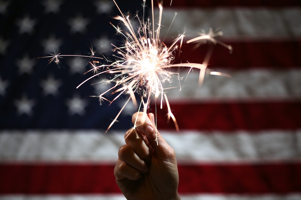 Sparkler being held in front of American flag