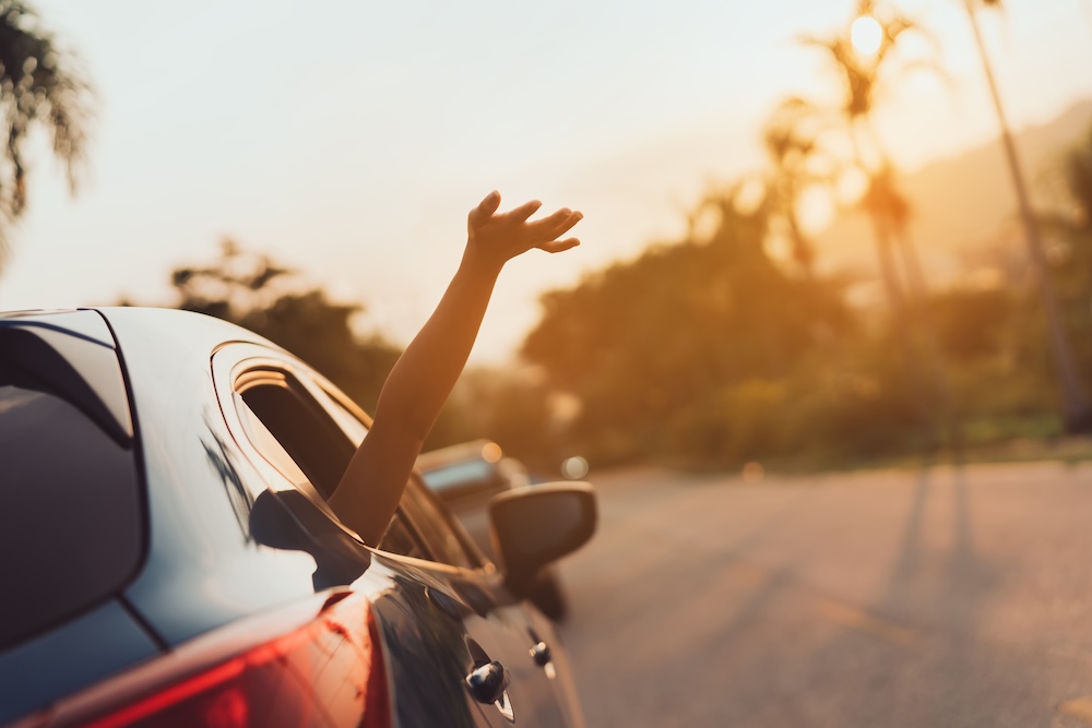Hatchback Car travel driving road, Hand waving out the window.