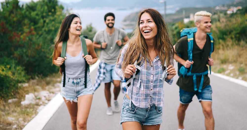 Group of friend travelers walking and having fun.