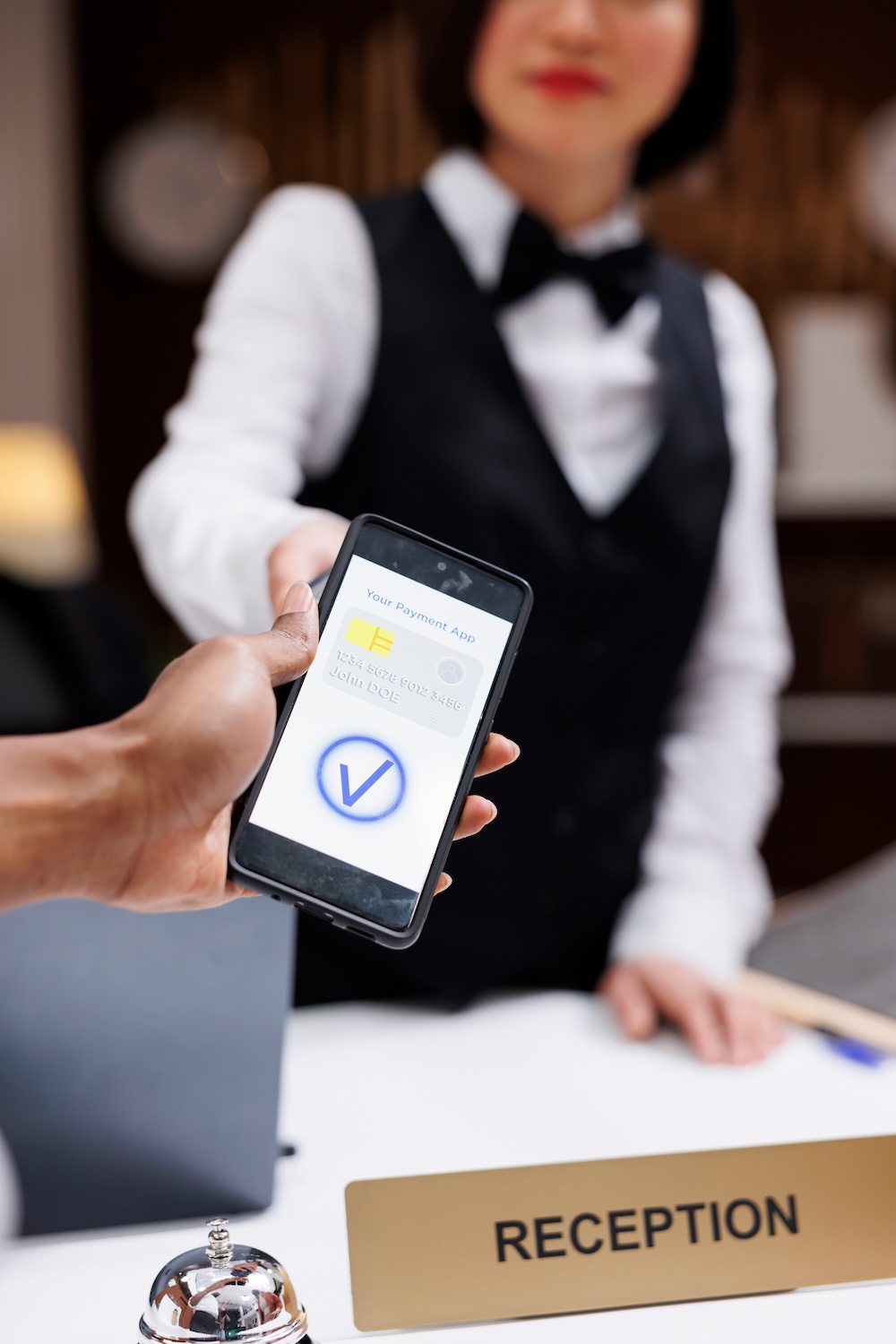 Guest paying with nfc on phone at pos terminal