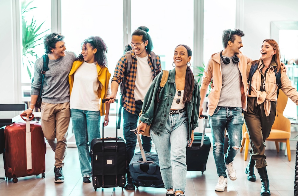 Young group of tourists with suitcases